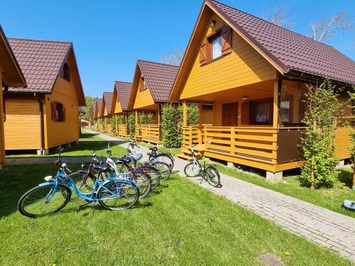 a group of bikes parked in front of a row of houses at Ośrodek wypoczynkowy nad morzem SEMI in Wicie