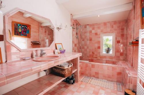 Baño alicatado de color rosa con lavabo y bañera en ILE DE RE - Villa Foulquier en Rivedoux-Plage