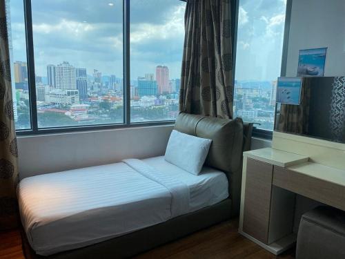 a hotel room with a bed and a large window at Mercu Summer Suite by Great Service in Kuala Lumpur