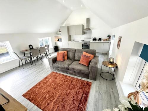 a living room with a couch and a table at Stylish Penthouse in a fantastic location! in Billingham