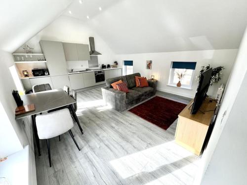 a living room with a couch and a table at Stylish Penthouse in a fantastic location! in Billingham