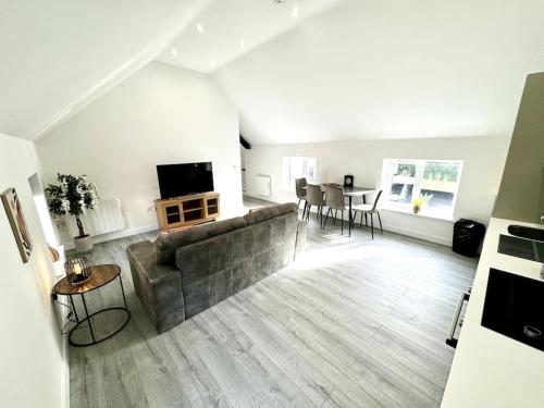 a living room with a couch and a table at Stylish Penthouse in a fantastic location! in Billingham