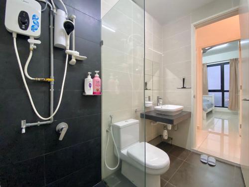 a bathroom with a shower and a toilet and a sink at Lovely Eco Home in Gelang Patah