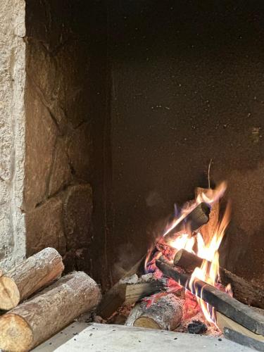 a fire is coming out of a brick oven at Maison de Hill Home in Dồng Văn