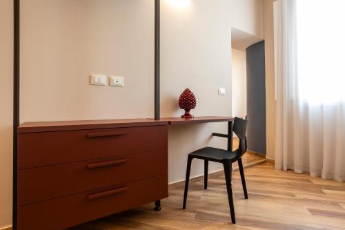 a dressing table with a chair and a dresser at Casa Marchesa in Modica