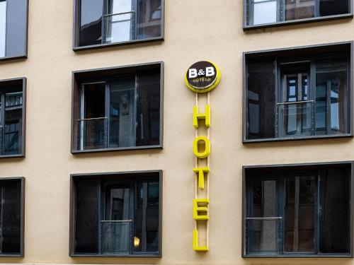 a building with a big sign on the side of it at B&B Hotel Leipzig-City in Leipzig