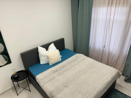a bedroom with a bed with two pillows on it at Stadtsuite mit Sauna in Wiener Neustadt 135 m2 in Wiener Neustadt