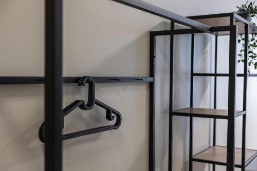a glass door with a metal rack next to a shelf at Bunks at Rode in Oslo