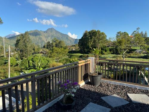 a balcony with a view of the mountains at Batur lake view in Kintamani