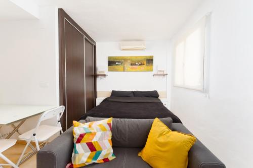 a bedroom with a bed and a couch at Port de Xabia V in Jávea
