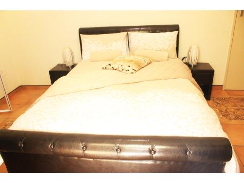 ein großes Bett in einem Zimmer mit zwei Nachttischen in der Unterkunft Peace at Home in Augustinium