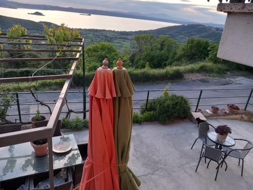 two dresses are standing on the balcony of a house at Reginella in Montefiascone