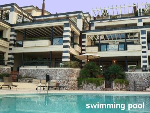 un grande edificio con piscina di fronte di casagratia a Taormina