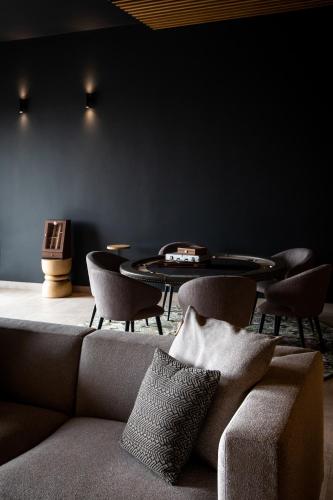 a living room with a couch and a table and chairs at KatarzynA Hotel in Svilengrad