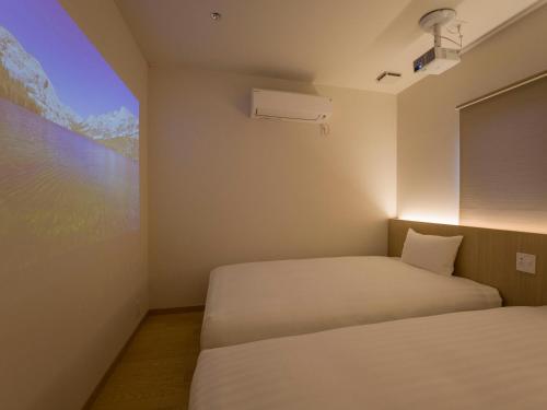 a bedroom with two beds and a large window at Rakuten STAY VILLA Kinugawa Riverside in Nikko