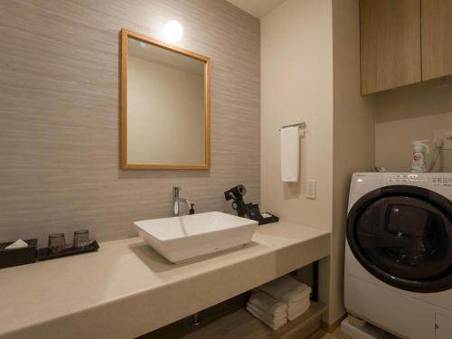 a bathroom with a sink and a washing machine at Rakuten STAY VILLA Kinugawa Riverside in Nikko
