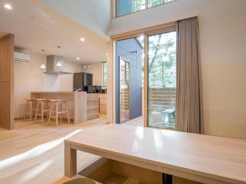 a kitchen and living room with a wooden table at Rakuten STAY VILLA Kinugawa Riverside in Nikko