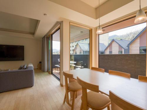 a living room with a table and chairs and a couch at Rakuten STAY VILLA Kinugawa Riverside in Nikko