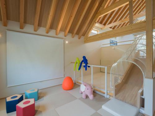 a childs room with a crib and a large screen at Rakuten STAY VILLA Kinugawa Riverside in Nikko