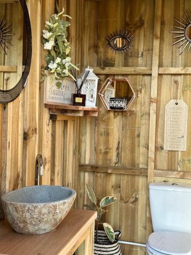 a bathroom with a sink and a wooden wall at Deerstone Glamping-Boulsworth Hill Dome Hot tub in Earby