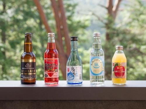 four bottles of beer sitting on a table at Rakuten STAY VILLA Kinugawa Riverside in Nikko