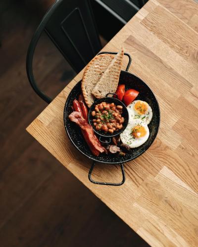 a plate of breakfast food on a table at Kolejowa ApartHotel in Warsaw
