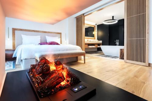 a bedroom with a bed and a bathroom with a fireplace at KatarzynA Hotel in Svilengrad