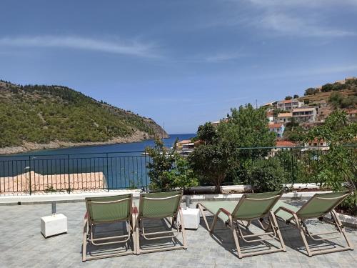 a group of chairs and a table on a patio at Dionos Villa with Jacuzzi in Asos