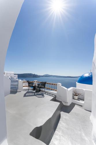 a balcony with a view of the ocean on a ship at Luxus VIP Suites in Oia
