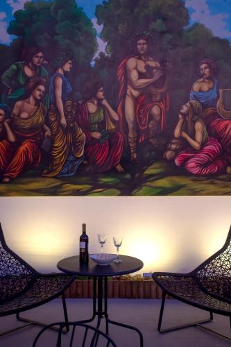 a painting of a group of people sitting around a table at Ourania by Heloni Apartments in Athens