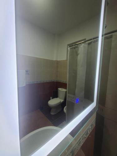 a bathroom with a toilet and a glass shower at Pogradeci Lake Guest House in Pogradec