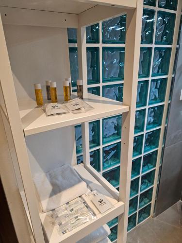 a bathroom with white shelves and glass windows at Victoria Royal Garden in Como