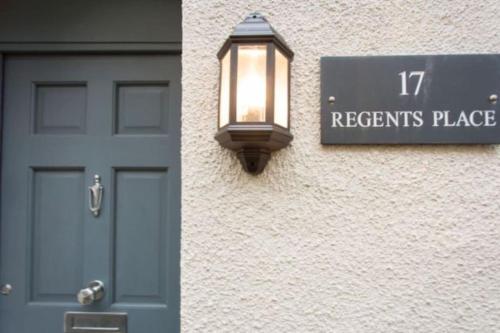 a door and a sign on the side of a building at Georgian Town House in Ilfracombe