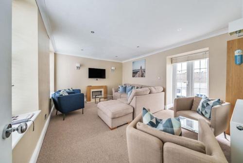 a living room with two couches and a tv at Georgian Town House in Ilfracombe