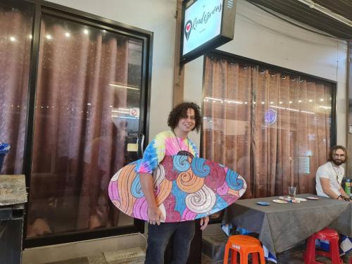 a woman is holding a doughnut costume at The Rendezvous Fullmoon Hostel in Haad Rin
