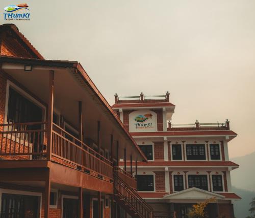 a building with a sign on the top of it at Thumki Resort, Balthali in Panauti