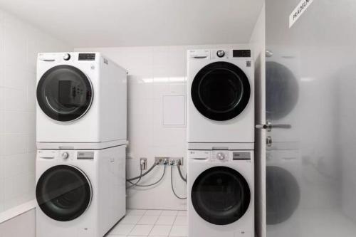 two washing machines are next to each other in a bathroom at Stylish Studio near Dejvická metro station in Prague