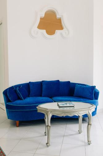 a blue couch and a coffee table in a living room at Villa Boheme Exclusive Luxury Suites in Positano