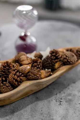 a wooden plate filled with nuts and pine cones at M&C homes Akrowa in Accra