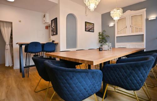 a dining room with a wooden table and blue chairs at Hotel Zehnthof in Cochem