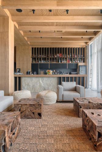 a living room with wooden tables and a bar at KatarzynA Hotel in Svilengrad