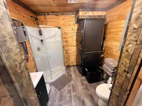 a small bathroom with a shower and a toilet at Sage Hill Cabin in Londonderry