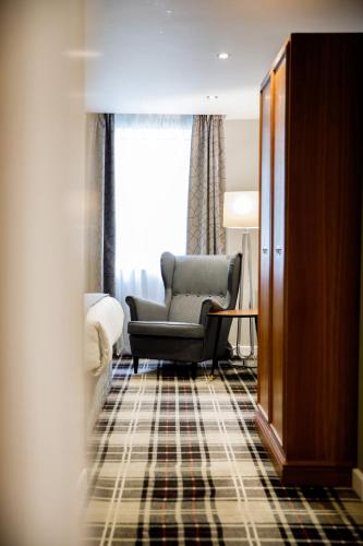 a living room with a chair and a couch at Heritage Park Pontypridd, Trademark Collection by Wyndham in Pontypridd