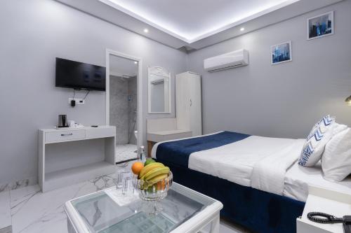 a hotel room with a bed and a bowl of fruit on a table at Hotel Downtown 17 in Chandīgarh