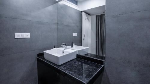 a bathroom with a white sink and a mirror at Hotel Downtown 17 in Chandīgarh