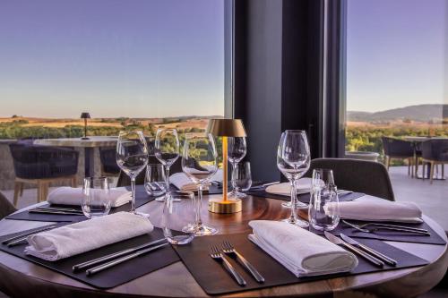 a table with wine glasses and napkins on it at KatarzynA Hotel in Svilengrad