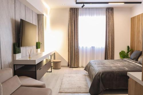 a bedroom with a bed and a desk and a window at Lagoon Studio 705 in Bucharest