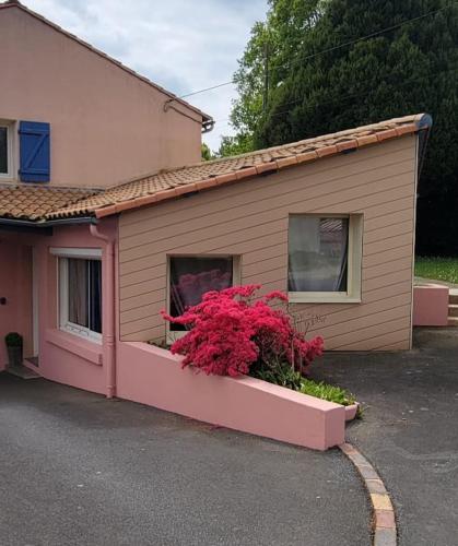 a house with a window box with flowers in it at Studio 6 in Le Boupère