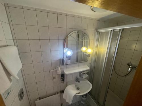 uma pequena casa de banho com um lavatório e um espelho em Hafner Hotel- Apartment em Stuttgart