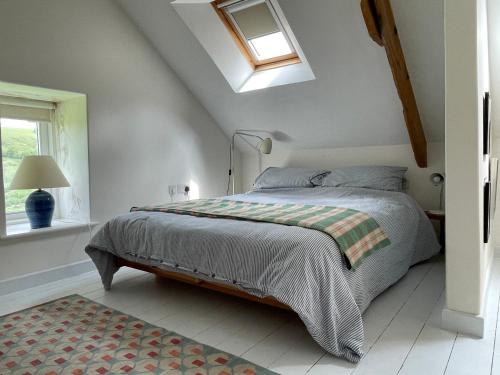 a bedroom with a bed and a window at Rhiwiau Self Catering in Carmarthen